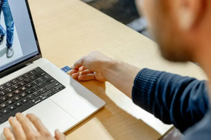 A man sitting in front of a laptop computer